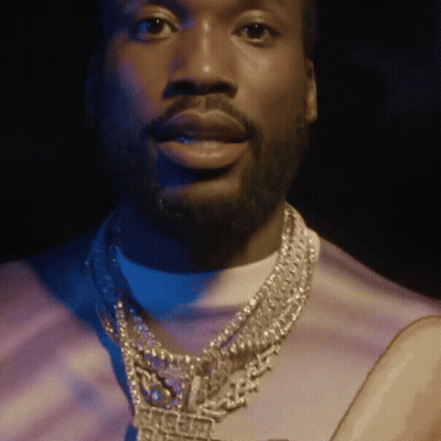 A Man With A Beard Is Wearing A Necklace That Says Ice Cube GIF