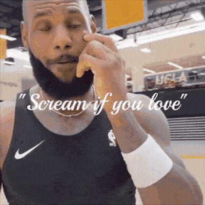 A Man With A Beard Is Wearing A Nike Tank Top And Wristband . GIF