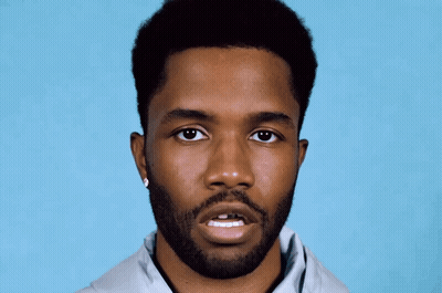 A Man With A Beard Is Wearing A Pair Of Earrings GIF