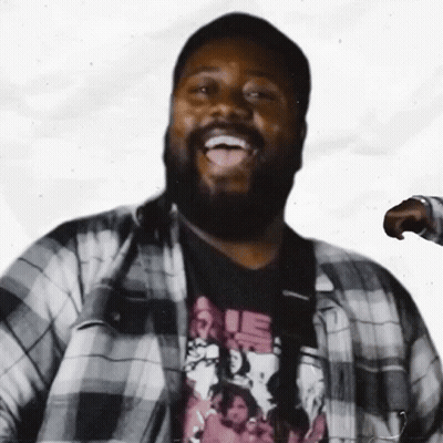 A Man With A Beard Is Wearing A Plaid Shirt And A T-Shirt That Says Rie GIF