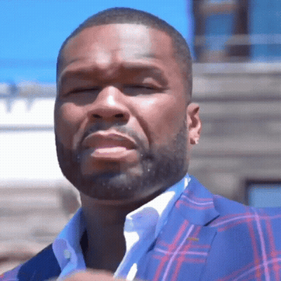 A Man With A Beard Is Wearing A Plaid Suit GIF