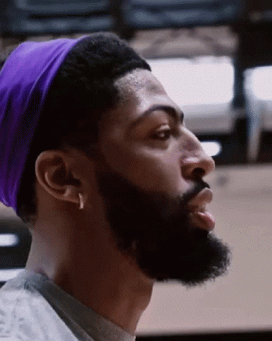 A Man With A Beard Is Wearing A Purple Headband GIF