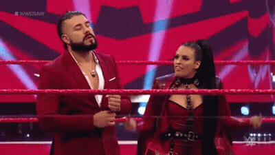 A Man With A Beard Is Wearing A Purple Suit And Giving A Thumbs Up Sign . GIF