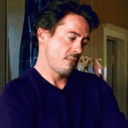 A Man With A Beard Is Wearing A Purple Sweater GIF