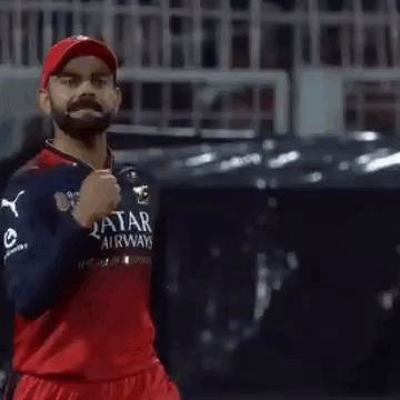 A Man With A Beard Is Wearing A Qatar Airways Jersey And A Red Hat . GIF