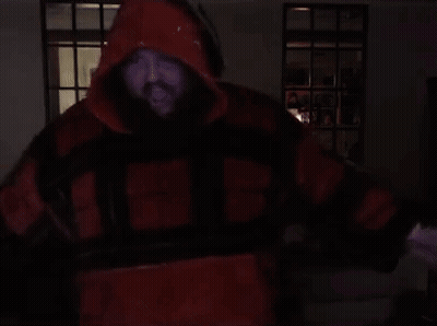 A Man With A Beard Is Wearing A Red And Black Jacket With The Letter H On The Front GIF