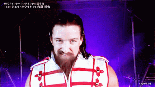 A Man With A Beard Is Wearing A Red And White Jacket GIF
