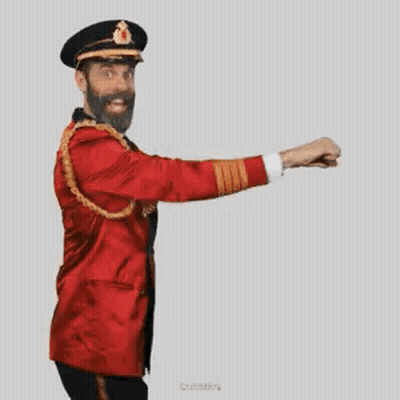 A Man With A Beard Is Wearing A Red Jacket And Hat And Is Dancing . GIF