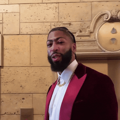 A Man With A Beard Is Wearing A Red Jacket And White Shirt GIF