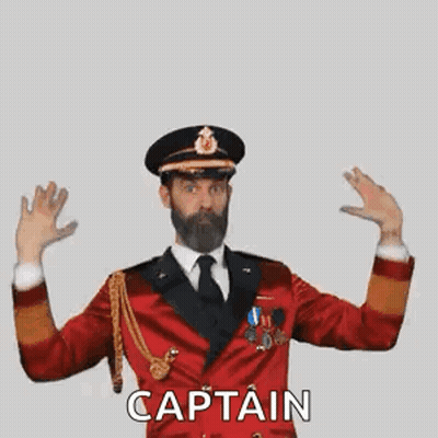 A Man With A Beard Is Wearing A Red Military Uniform And Making A Captain Gesture . GIF