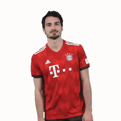 A Man With A Beard Is Wearing A Red T-Mobile Jersey And Making A Funny Face . GIF