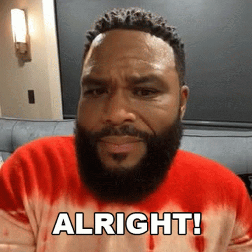 A Man With A Beard Is Wearing A Red Tie Dye Sweater And Saying Alright ! GIF