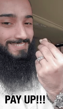 A Man With A Beard Is Wearing A Ring On His Finger And The Words Pay Up !!! Are Below Him GIF