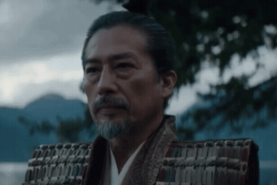 A Man With A Beard Is Wearing A Samurai Costume And Armor . GIF