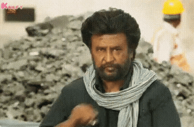 A Man With A Beard Is Wearing A Scarf Around His Neck . GIF