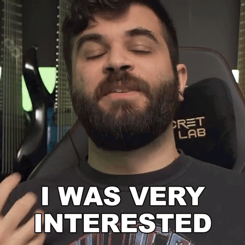 A Man With A Beard Is Wearing A Shirt That Says " I Was Very Interested " GIF