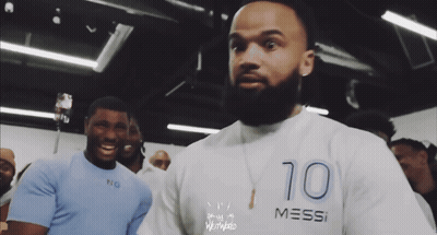 A Man With A Beard Is Wearing A Shirt That Says Messi GIF
