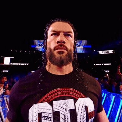 A Man With A Beard Is Wearing A Shirt That Says ' Smack Down ' On It GIF
