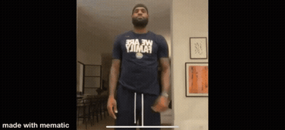 A Man With A Beard Is Wearing A Shirt That Says ' Yjima ' On It GIF