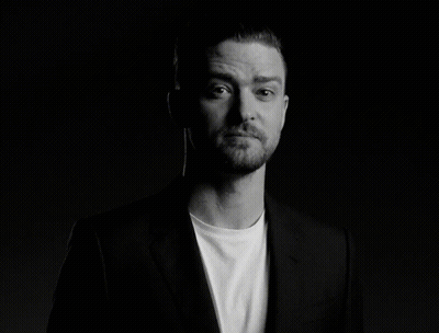 A Man With A Beard Is Wearing A Suit And A White Shirt GIF