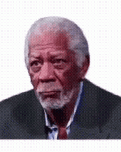 A Man With A Beard Is Wearing A Suit And Tie . GIF