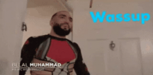 A Man With A Beard Is Wearing A Superhero Costume And The Word Wassup Is On The Bottom GIF