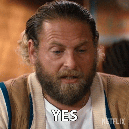 A Man With A Beard Is Wearing A Sweater And Says Yes GIF