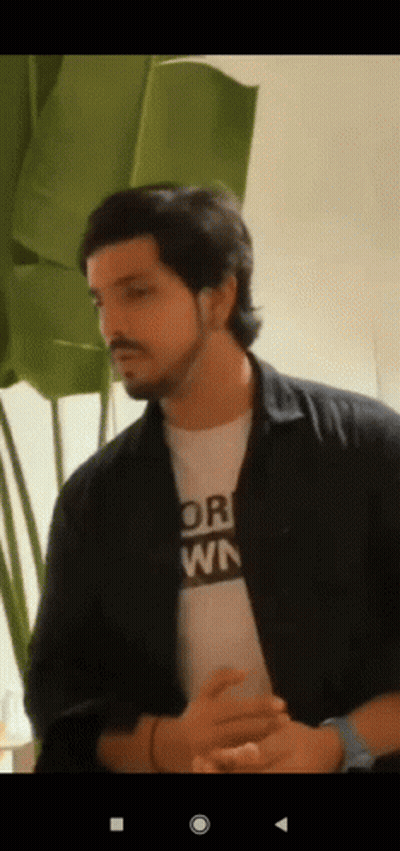 A Man With A Beard Is Wearing A T-Shirt That Says " Or " On It . GIF