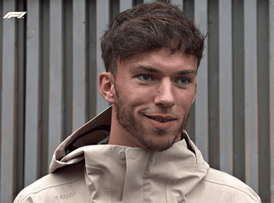 A Man With A Beard Is Wearing A Tan Jacket That Says Mammut On The Front GIF