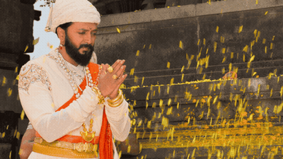 A Man With A Beard Is Wearing A Turban And Praying With His Hands Folded GIF