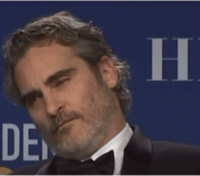 A Man With A Beard Is Wearing A Tuxedo And A Bow Tie . GIF