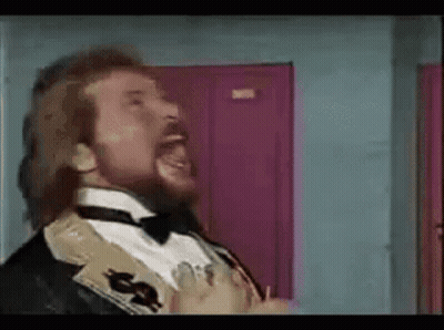 A Man With A Beard Is Wearing A Tuxedo And Bow Tie GIF