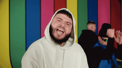 A Man With A Beard Is Wearing A White Hoodie That Says ' Supreme ' On It GIF