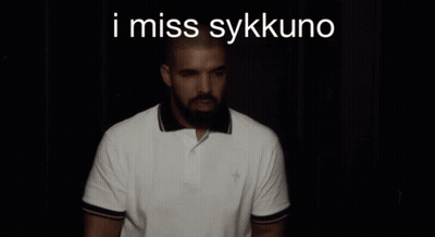A Man With A Beard Is Wearing A White Polo Shirt With The Words I Miss Sykkuno On The Bottom GIF