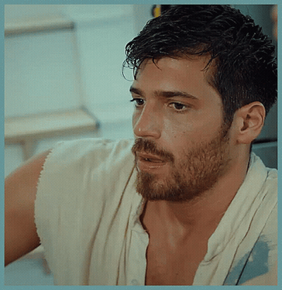 A Man With A Beard Is Wearing A White Shirt And A White Towel Around His Neck GIF
