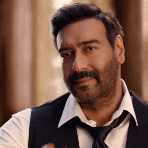 A Man With A Beard Is Wearing A White Shirt And Black Vest And Tie GIF