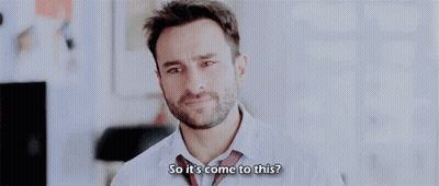 A Man With A Beard Is Wearing A White Shirt And Tie . GIF