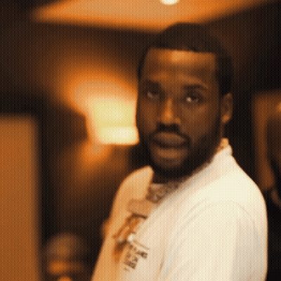 A Man With A Beard Is Wearing A White Shirt That Says ' A ' On It GIF
