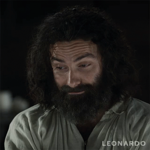 A Man With A Beard Is Wearing A White Shirt That Says Leonardo GIF