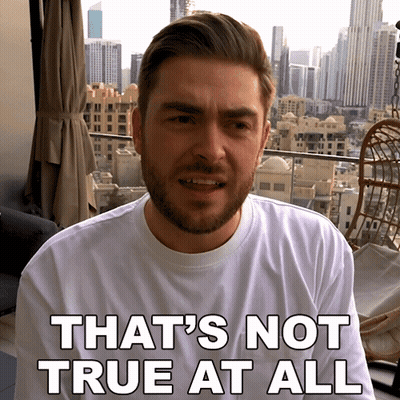 A Man With A Beard Is Wearing A White Shirt That Says " That 'S Not True At All " GIF