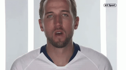 A Man With A Beard Is Wearing A White Shirt With A Bt Sport Logo On It GIF