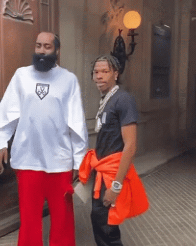 A Man With A Beard Is Wearing A White Shirt With A Logo On It GIF