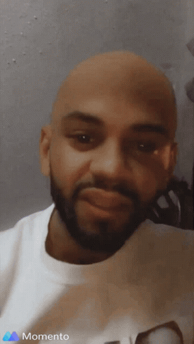 A Man With A Beard Is Wearing A White Shirt With The Word Momento On It GIF