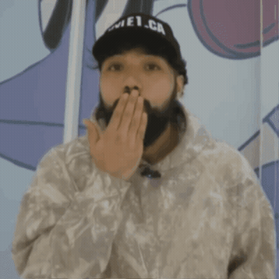 A Man With A Beard Is Wearing A White Sweatshirt With The Word Supreme On It GIF