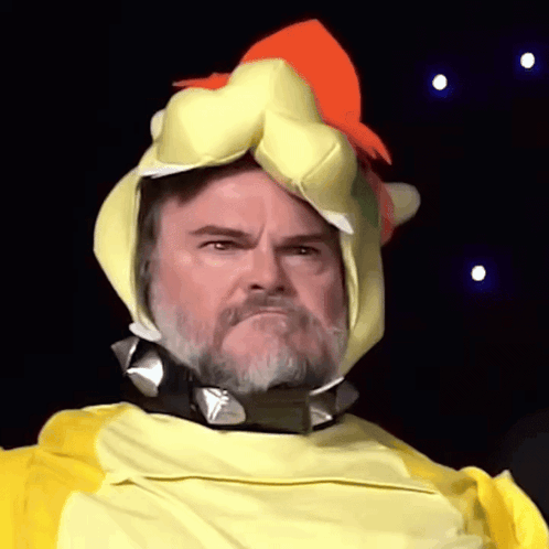 A Man With A Beard Is Wearing A Yellow And Orange Chicken Costume GIF