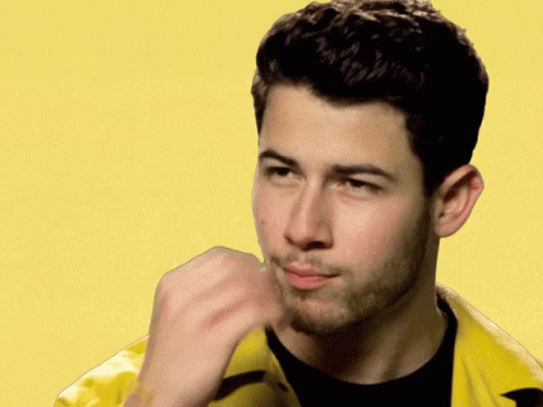 A Man With A Beard Is Wearing A Yellow Jacket And A Black Shirt GIF