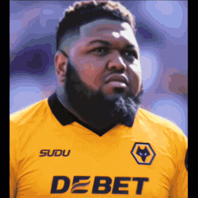 A Man With A Beard Is Wearing A Yellow Shirt That Says Debet On It GIF