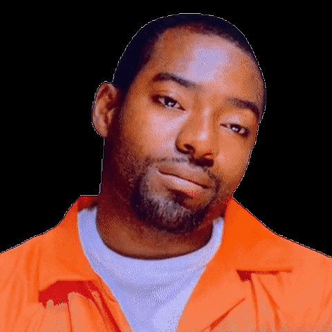 A Man With A Beard Is Wearing An Orange Jacket GIF
