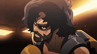A Man With A Beard Is Wearing Boxing Gloves In A Dark Room GIF