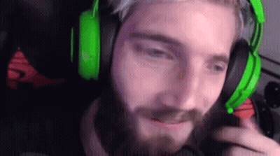 A Man With A Beard Is Wearing Green Headphones And A Microphone . GIF